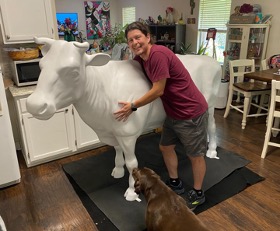 McKinney posing with cow pup