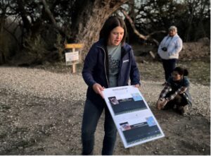A woman holds up a picture chart