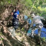 Volunteers clearing trash from river beds.