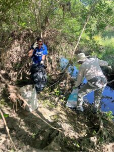 Volunteers clearing trash from river beds.