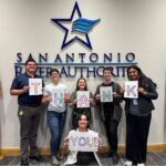 River Authority Staff hold thank you sign