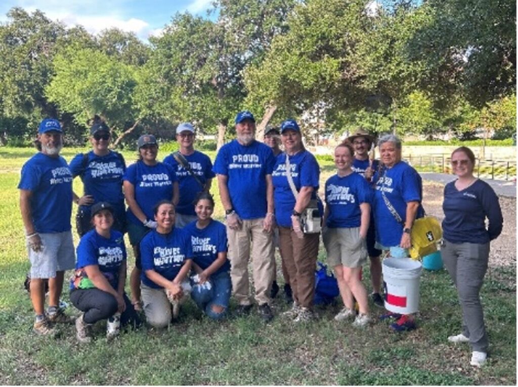 Volunteers stand together as they complete for an apple snail removal event. 