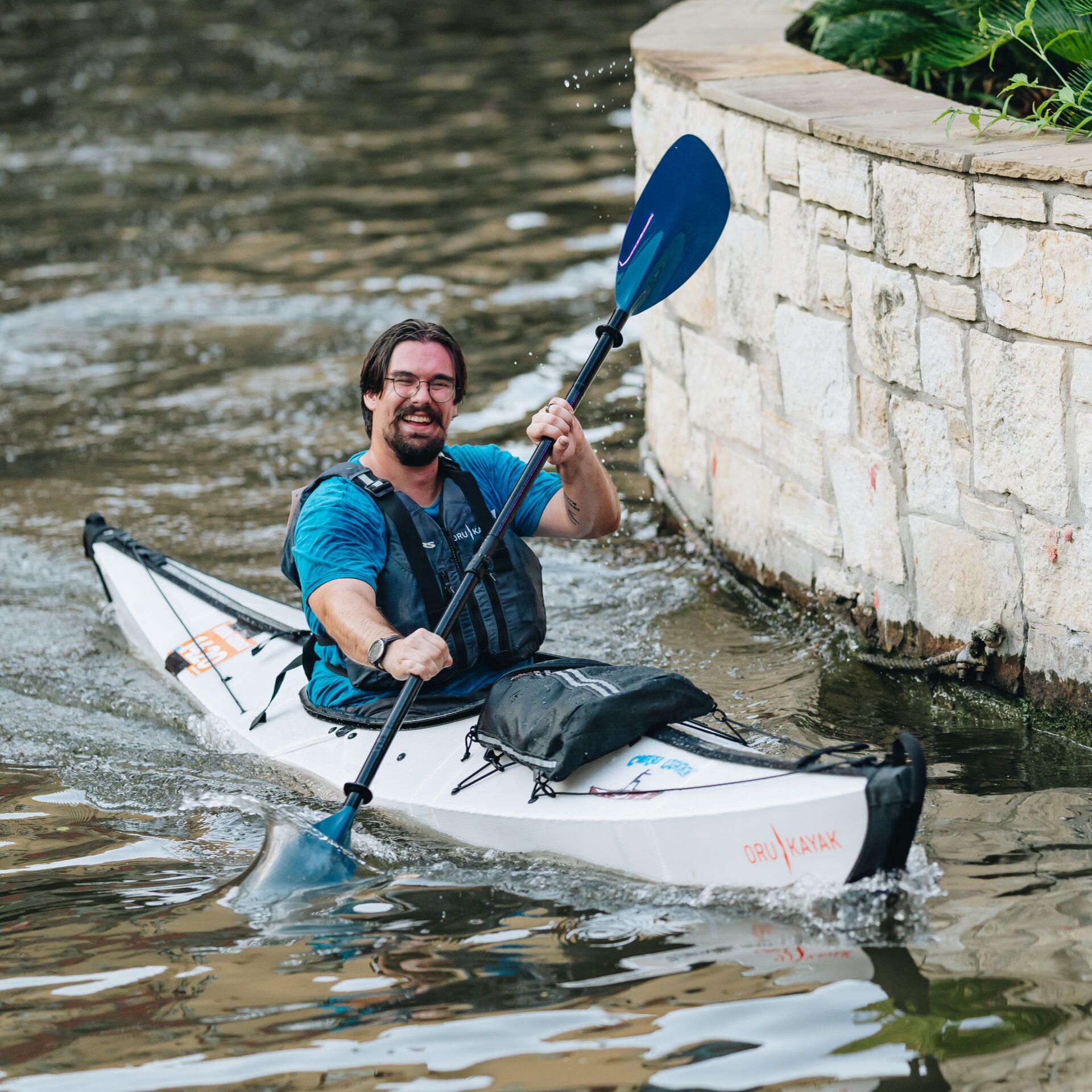 A kayak racer paddles down the San Antonio River