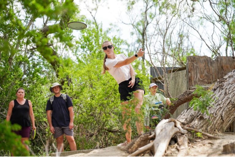 A woman throwing a disc