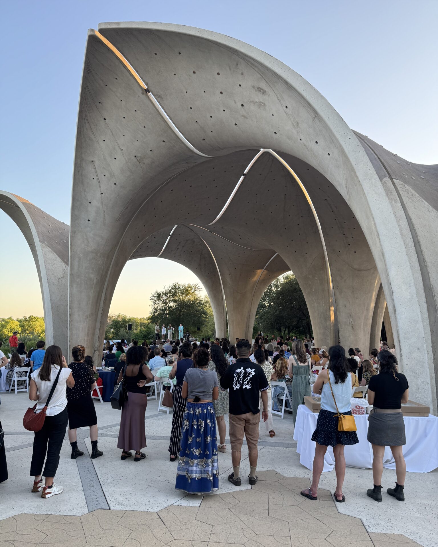 A group of people stand in front of Confluence Park