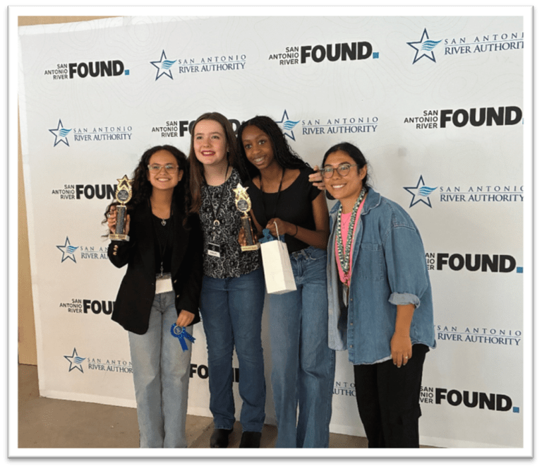 A group of young girls pose for a photo after winning the STEM Challenge competition