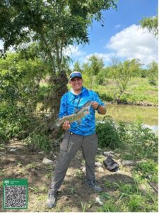 A man holds a fish