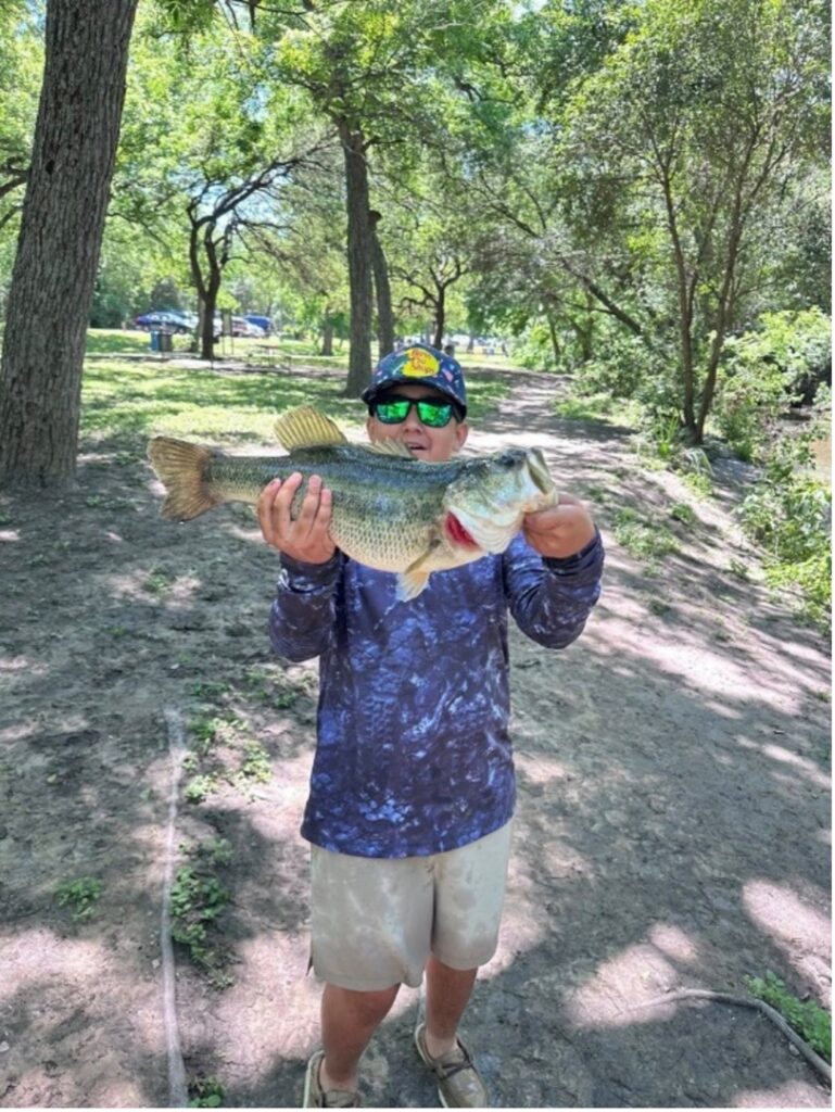 A man holds up his fish
