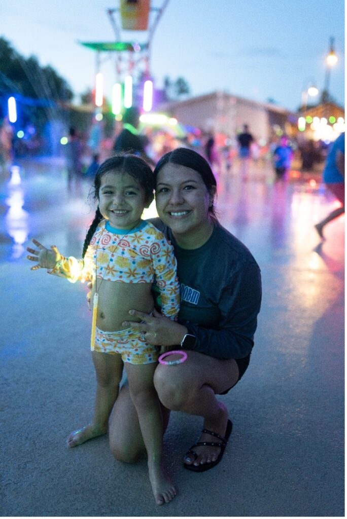 A parent and child at a splashpad