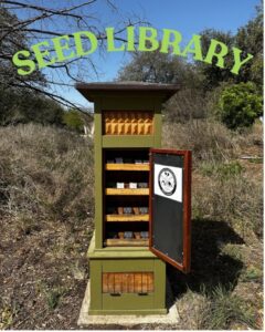 A Seed library shelf in the middle of a park field