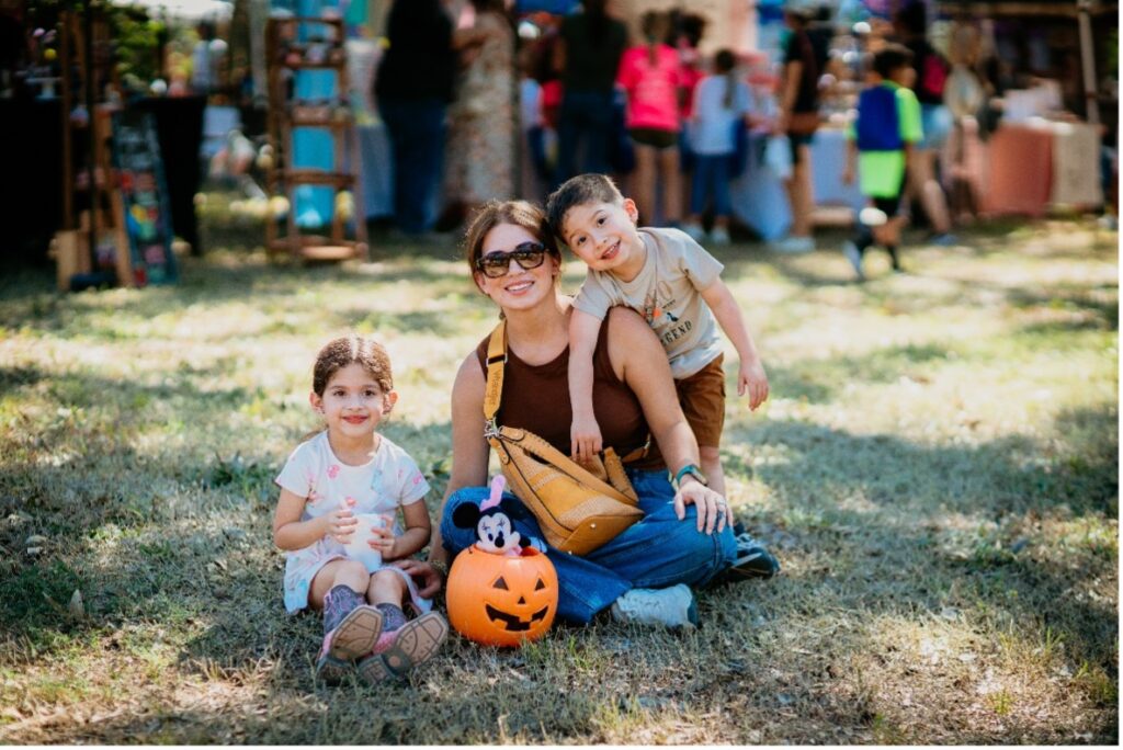 A woman and two children pose together at Fall Fest.