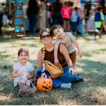 A woman and two children pose together at Fall Fest.