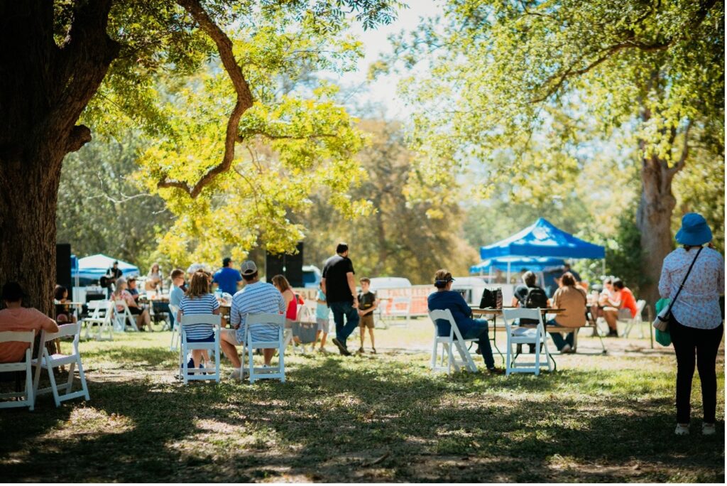 A Group of people gather on the festival grounds at Helton Nature Park