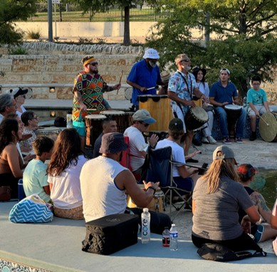 A group of people gathered together during a drum circle event